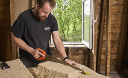 Editorial Photograph of Joiner cutting insulation for Sisalwool company based just outside Edinburgh